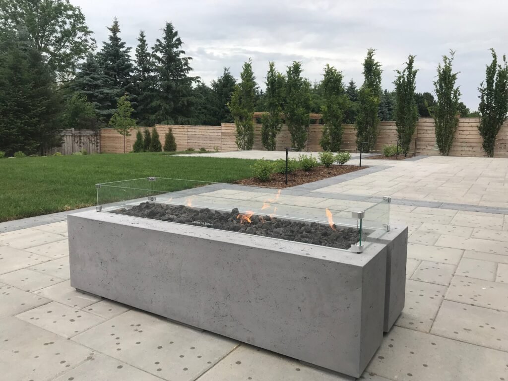 Concrete fire table on a large porcelain paver patio