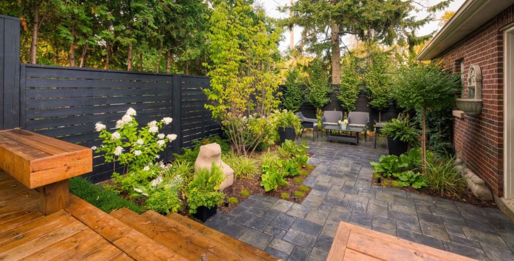 Backyard patio with a built-in cedar bench, hydrangeas and garden beds
