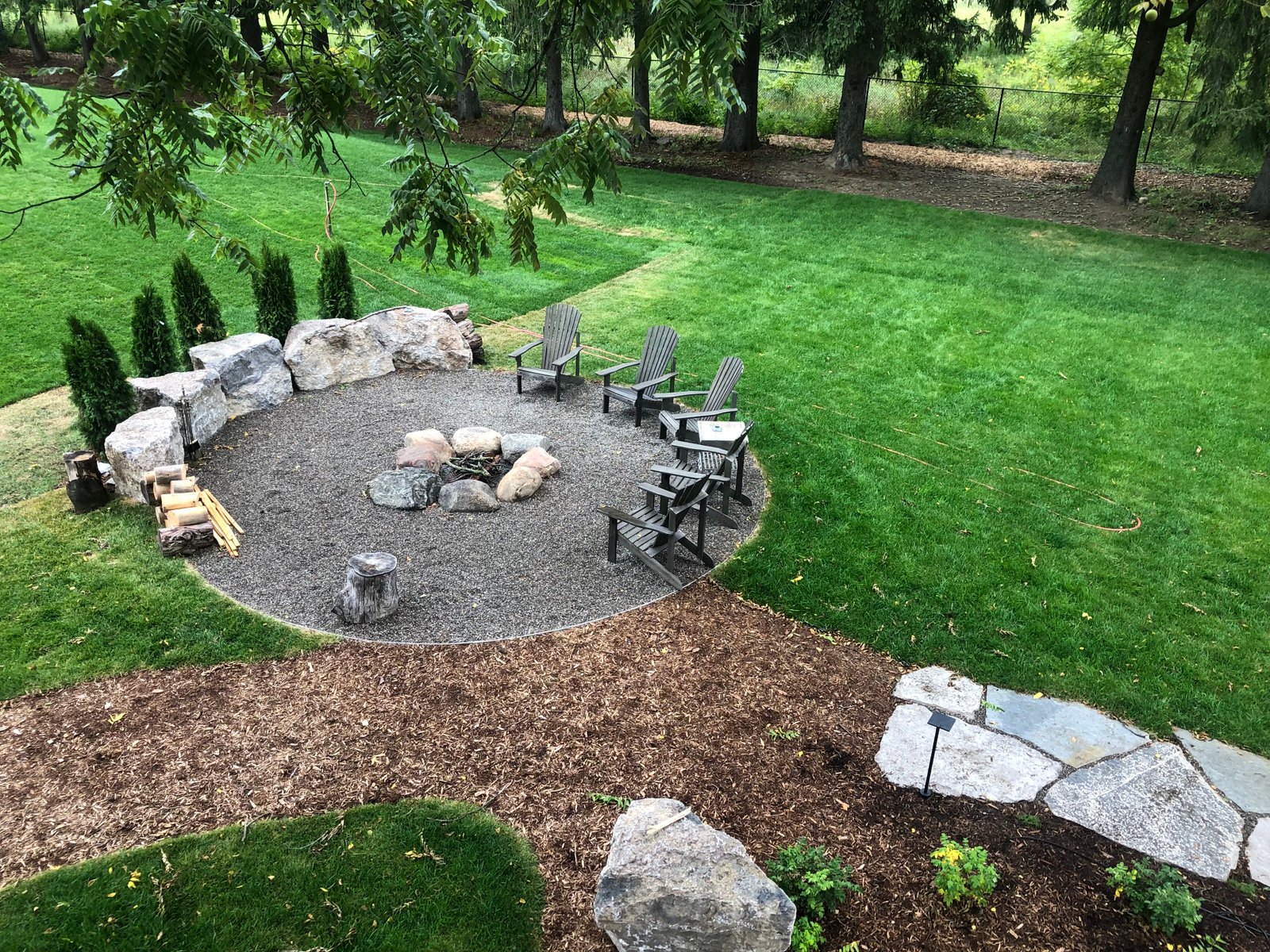 Stone fire pit and seating built by Thor Construction