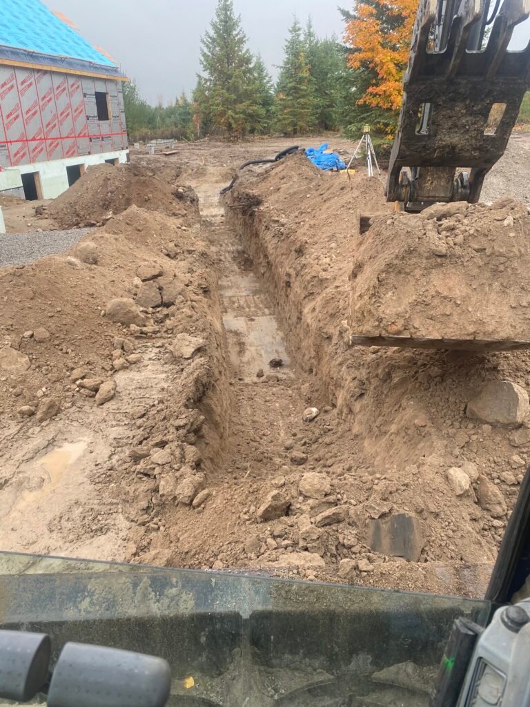 A service trench dug by Thor Construction, seen from the excavator cab
