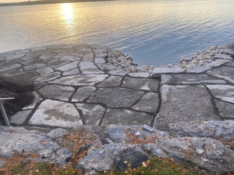 Flagstone and armour stone at the lake at golden hour, built by Thor Construction