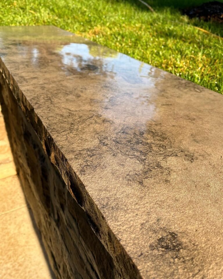 Natural stone copings on a masonry wall. Thor Construction job photo.