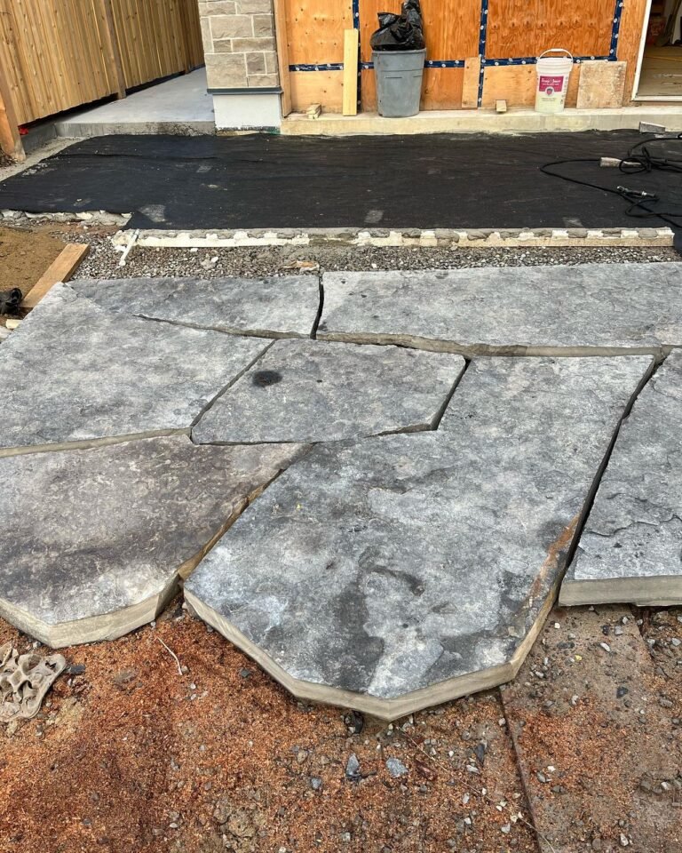 Laying out jumbo flagstone. Thor Construction job photo.