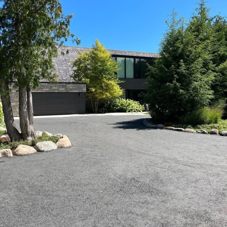 Granite boulder edging along a new driveway. Thor Construction job photo.