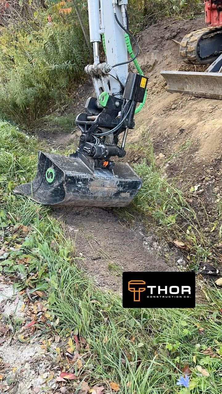 Ditching for a new culvert. Thor Construction job video.