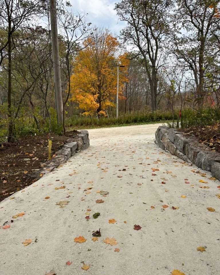 Armour stone walls along a new driveway. Thor Construction job photo.