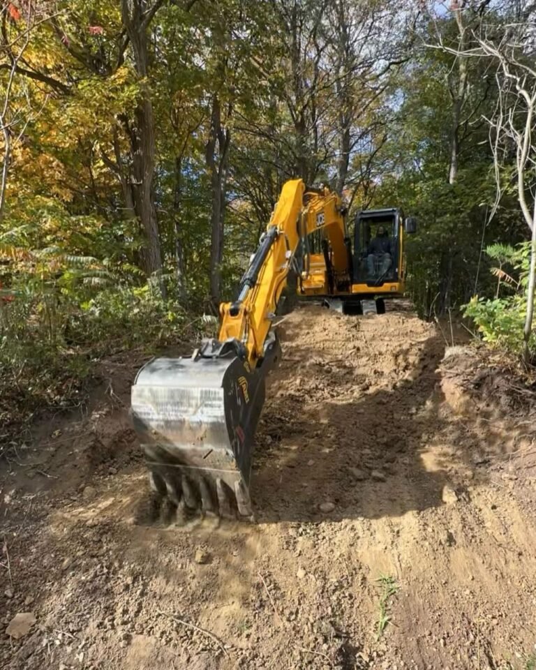 Armour stone walls along a new driveway. Thor Construction job photo.