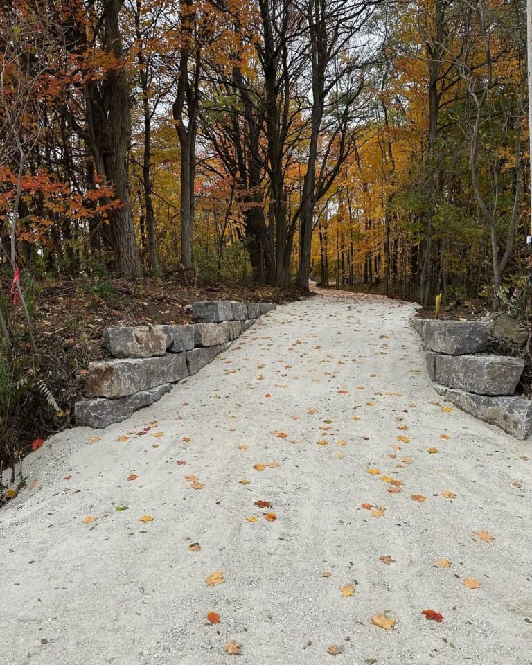 Armour stone walls along a new driveway. Thor Construction job photo.