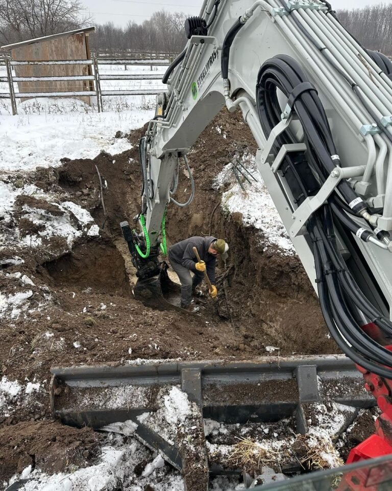 Digging up a leaking well line in winter, Kawartha Lakes. Thor Construction job photo.