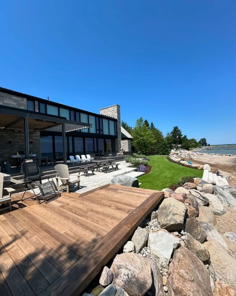 Finished landscape: sod, boulders and a stone patio. Thor Construction job photo.