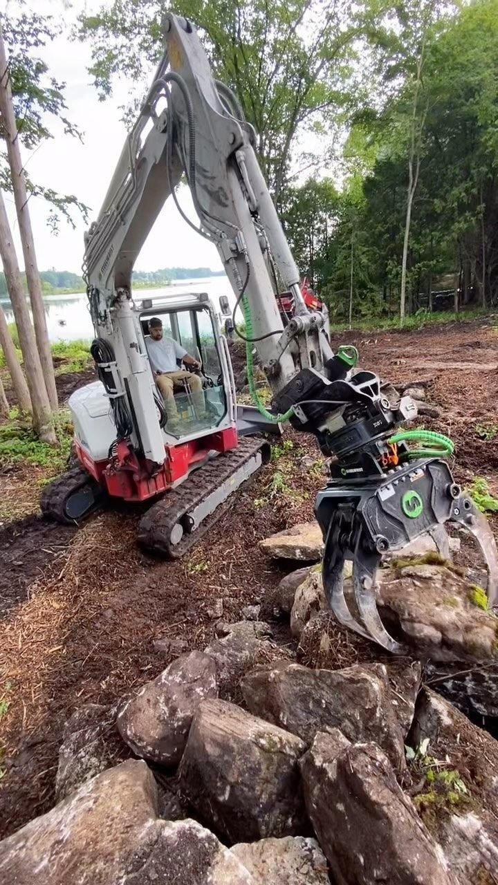 Harvesting native stone on site for a retaining wall, Bobcaygeon. Thor Construction job video.