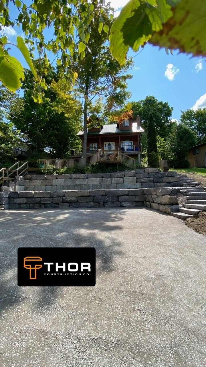 Retaining wall and stairs, complete, Ennismore. Thor Construction job video.