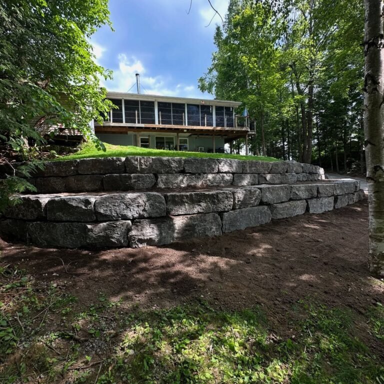 Armour stone retaining wall and natural stone steps, Catchacoma. Thor Construction job photo.