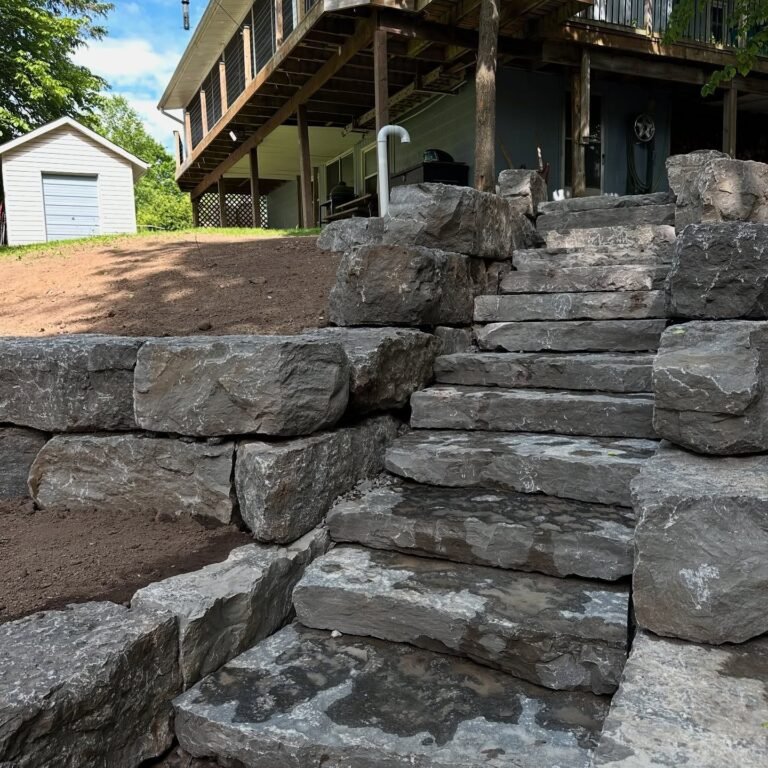 Armour stone retaining wall and natural stone steps, Catchacoma. Thor Construction job photo.