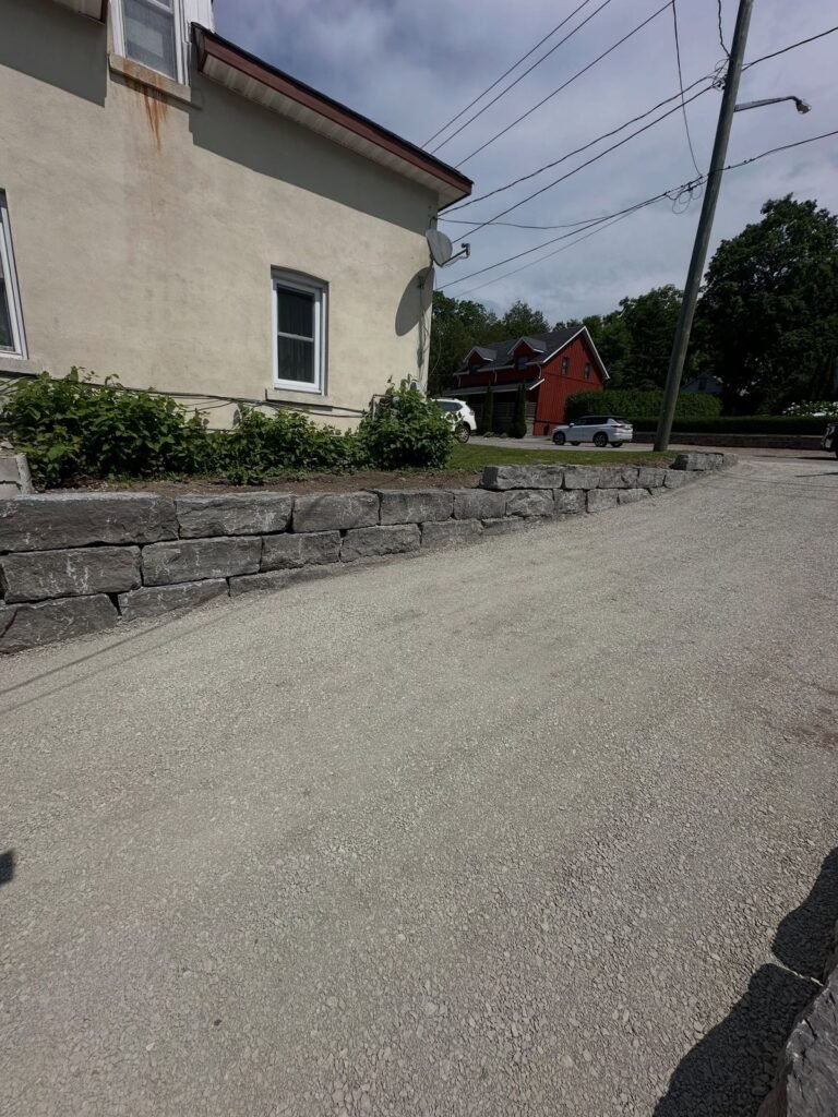 New driveway with armour stone retaining walls. Thor Construction job photo.