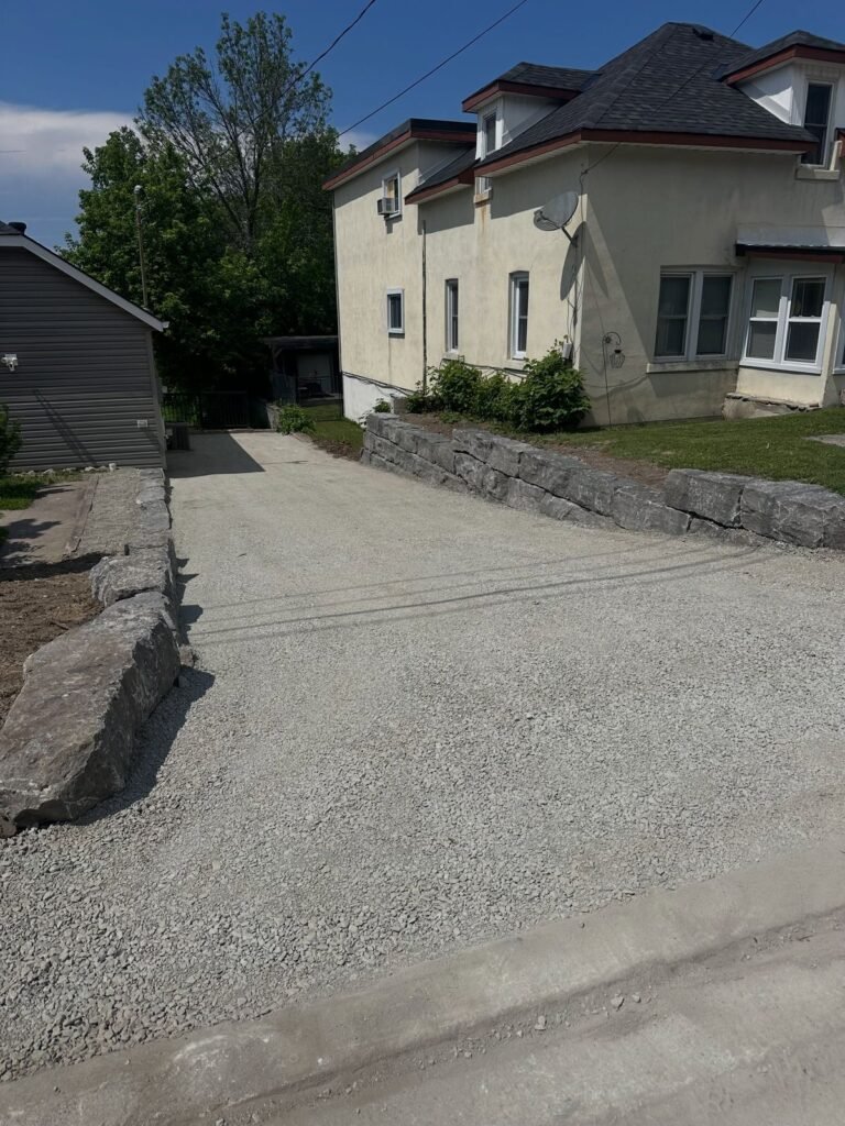 New driveway with armour stone retaining walls. Thor Construction job photo.