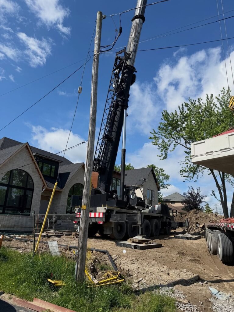 Craning a two-piece septic tank over a new build, Pickering. Thor Construction job photo.