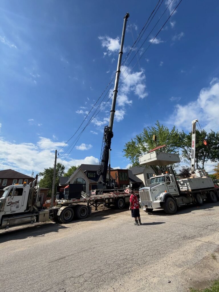 Craning a two-piece septic tank over a new build, Pickering. Thor Construction job photo.